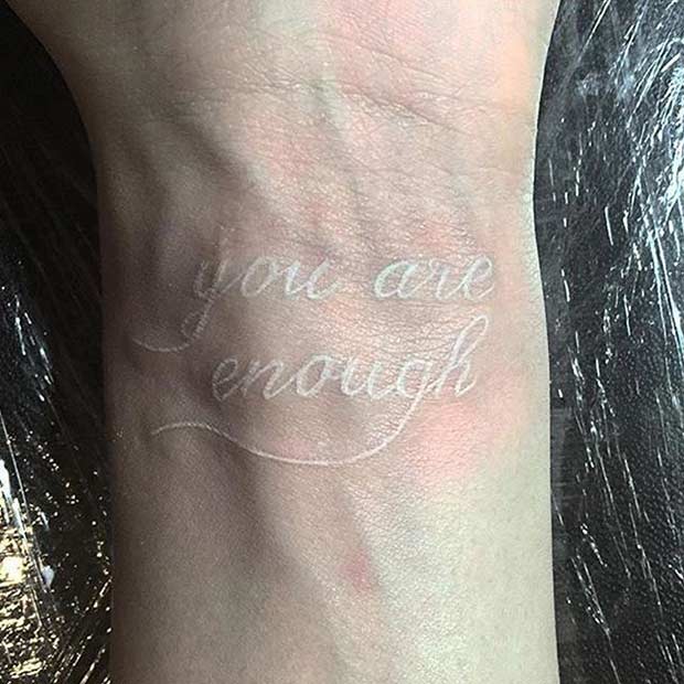White Ink Quote Wrist Tattoo
