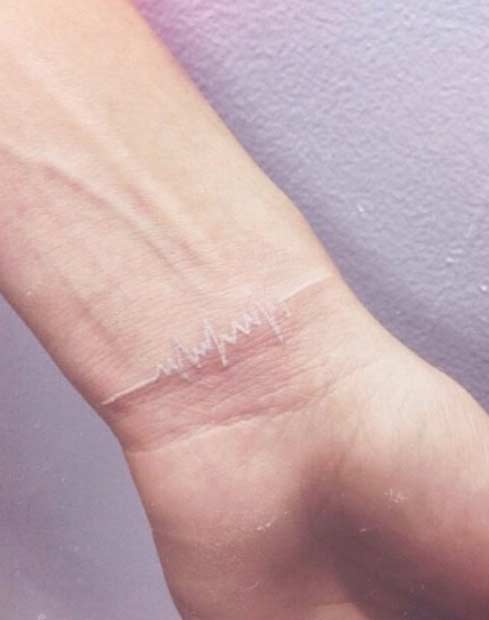 White Ink Heartbeat Wrist Tattoo