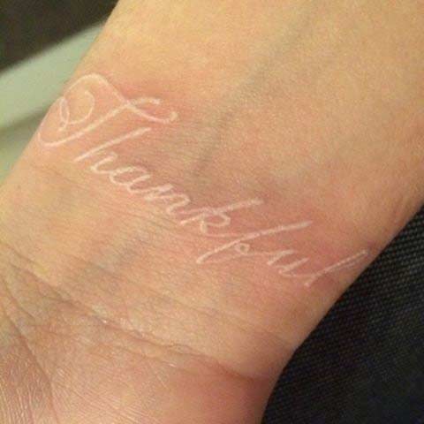 White Ink Quote Wrist Tattoo Idea