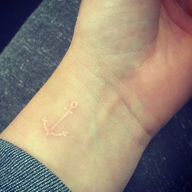 Small White Ink Anchor Tattoo