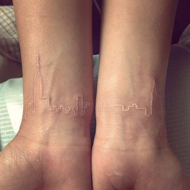 White Ink City Landscape Wrist Tattoo