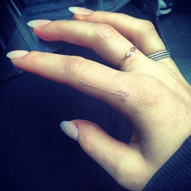 White Ink Arrow Finger Tattoo