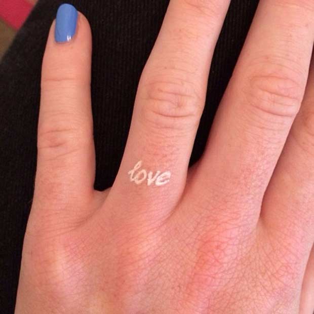Tiny White Ink Love Finger Tattoo