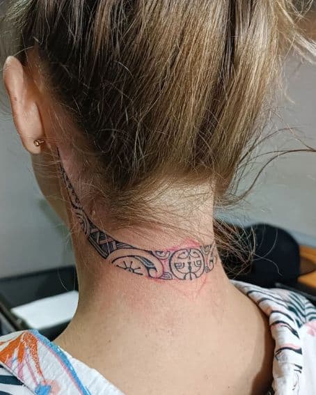 A small Polynesian tattoo behind the neck