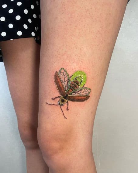 Colorful Firefly Tattoo Above The Knee
