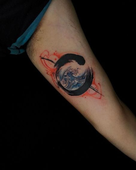 Enso Tattoo on the Arm with Water Waves