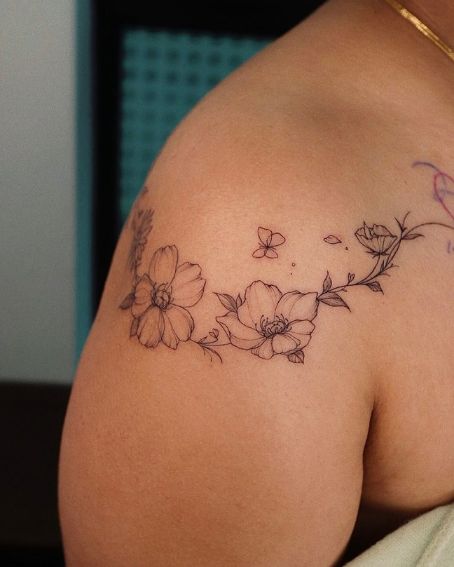 Flowers Tattoo Wrapping Around The Shoulder