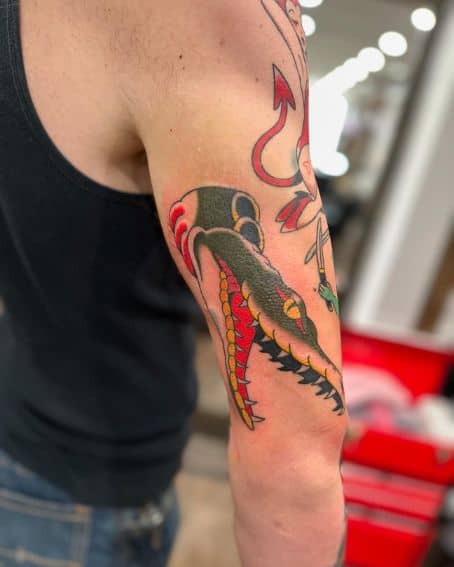 Lines and Black Healed Gator Tattoo