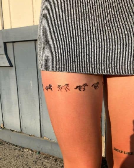 Tattoo of Tiny Running Horses on the Thigh