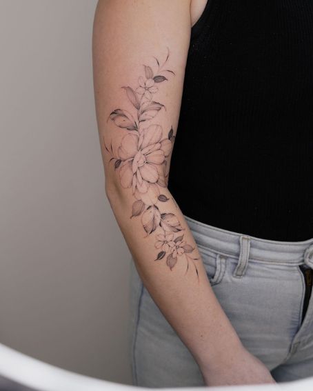 Trailing Delicate Magnolia Tattoo on Arm